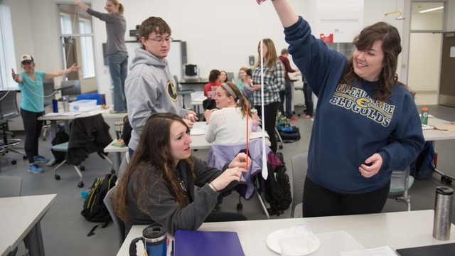 Educations students playing with slime in sensory learning class