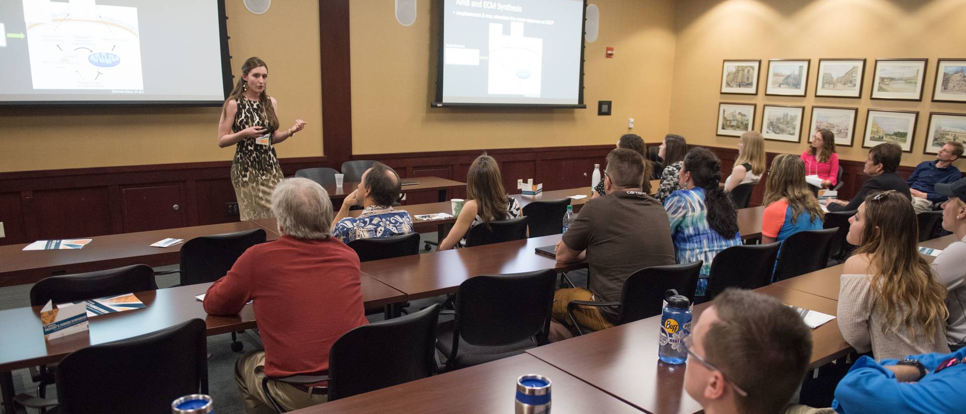 People listen to a presentation during an Honors Symposium event.