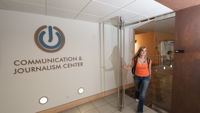 Student walking out of communication and journalism center