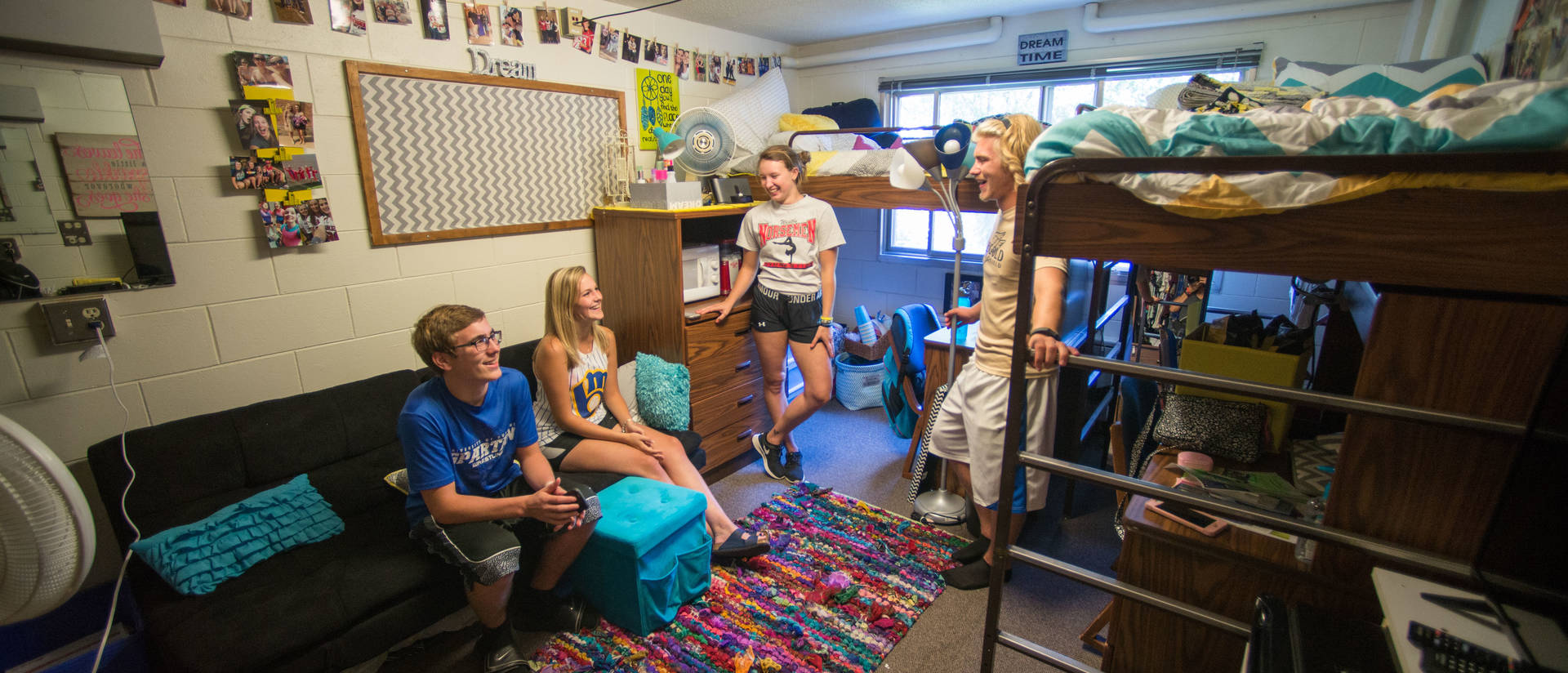 Four UWEC students hanging out in their dorm room
