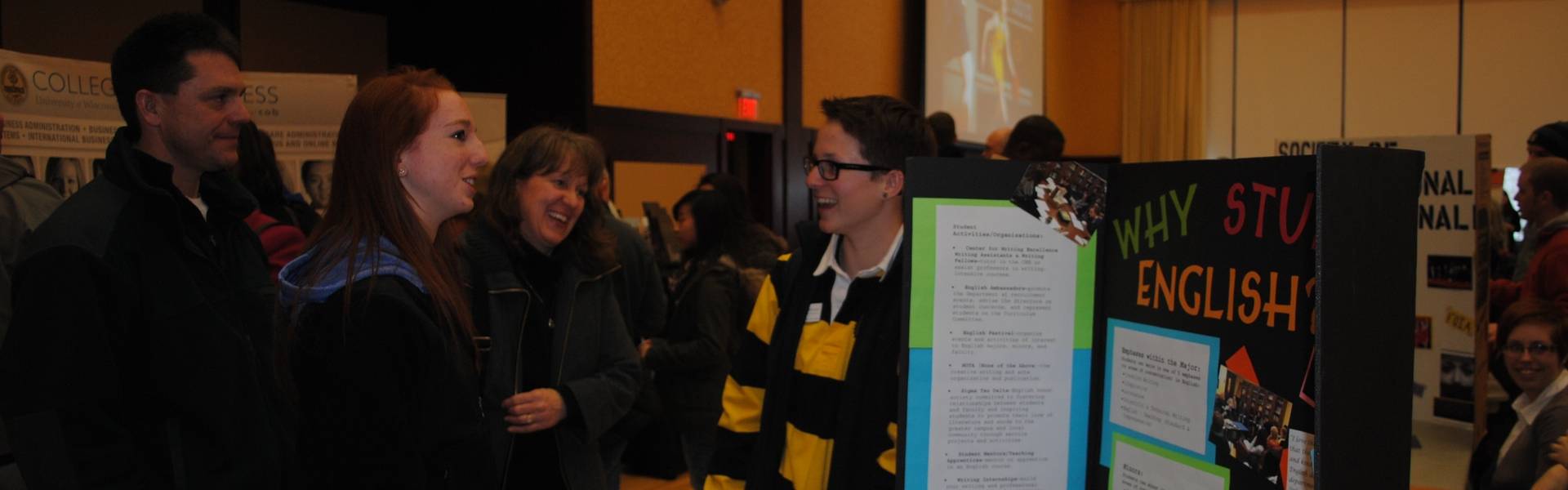 An English student presents a student organization to a BluGold and their parents.
