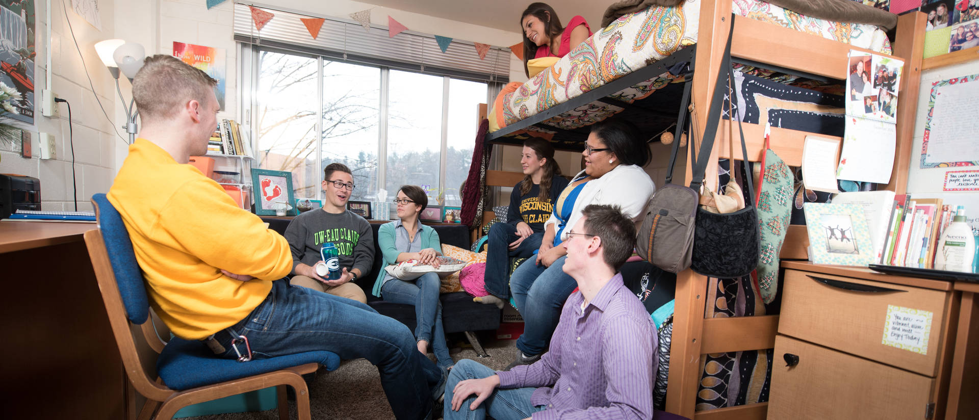 A Group of UWEC students gathered in a dorm room socializing