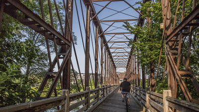 Biker crossing the river on the bridge at Phoenix Park