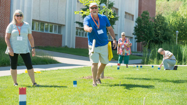 Men and women playing kubb at Senior Americans Day program put on UW-Eau Claire Continuing Education