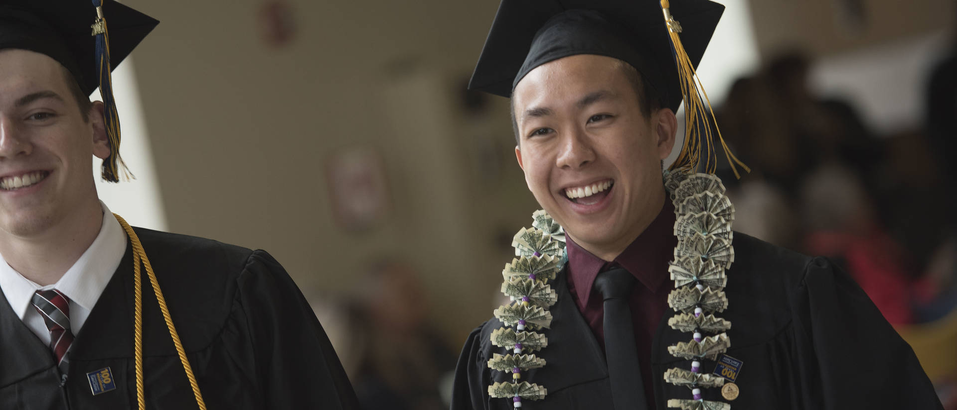 Male student on commencement day in cap and gown