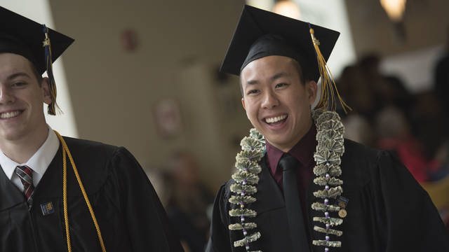 Male student on commencement day in cap and gown