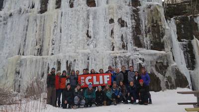 Students in front of ice wall on a climbing trip