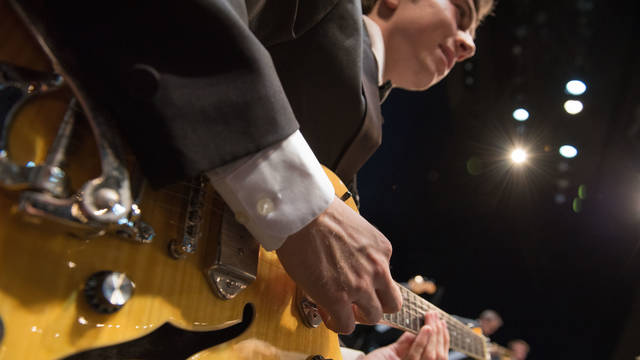 Student plays guitar during jazz gala concert