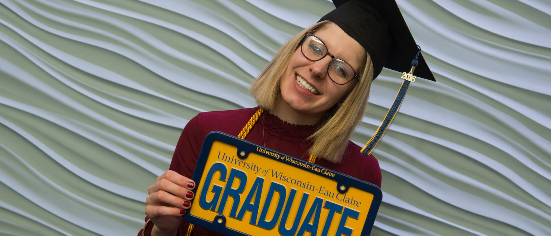 Young woman graduate celebrating at UW-Eau Claire’s Davies Center.