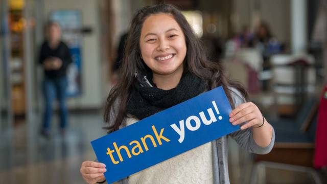 UW-Eau Claire scholarship recipient Manee Yang holds Thank You card