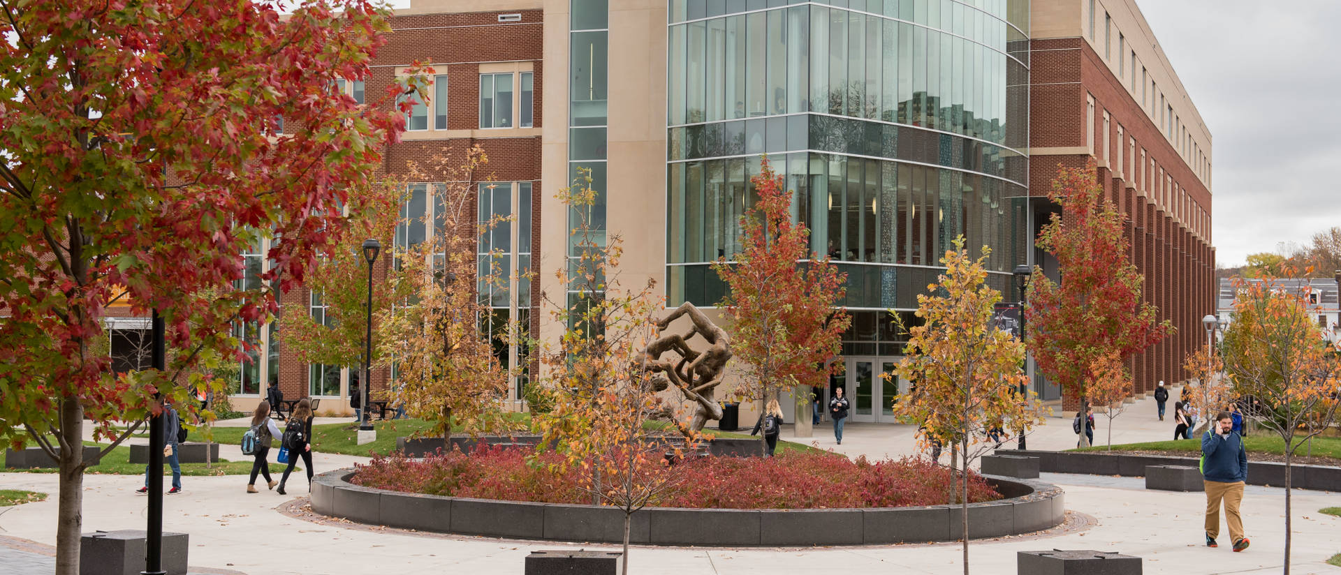 Faculty and students make their way through lower campus near Centennial Hall.