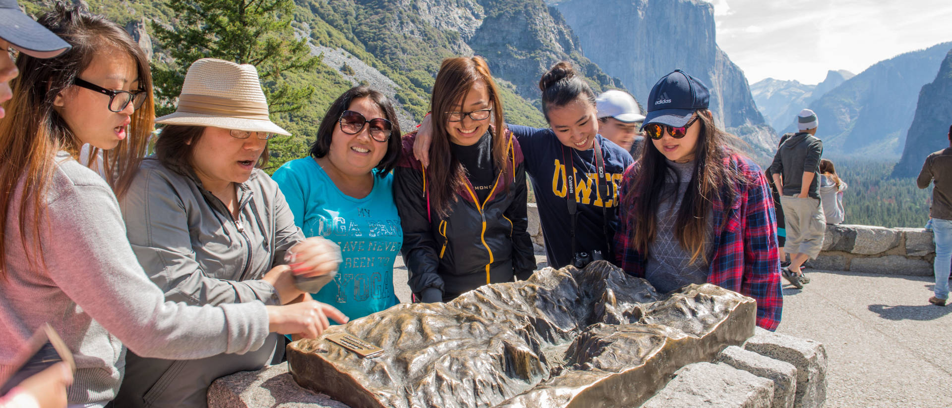 Two female students near a waterfall on a Hmong immersion trip to Fresno, CA