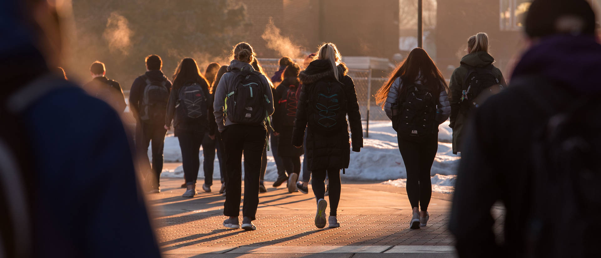 Students walking across UW-Eau Claire campus mall in winter