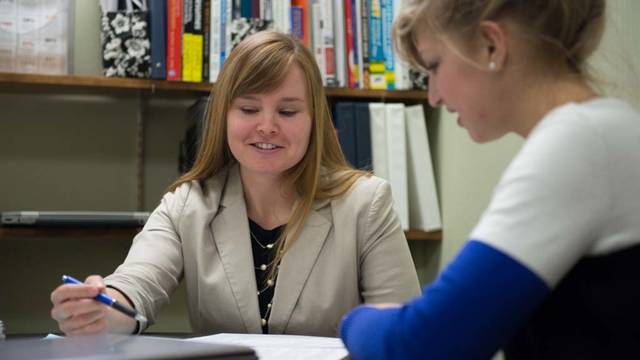 Career services advisor helps a student with resume.