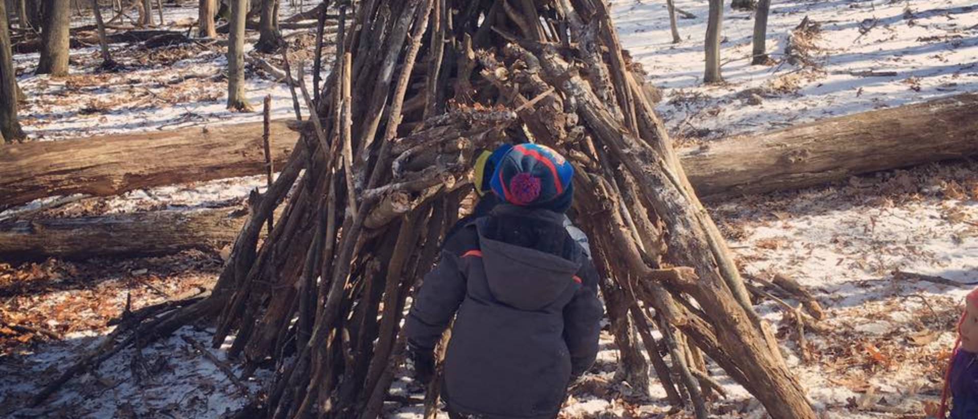 Kids at the children's nature academy building a fort